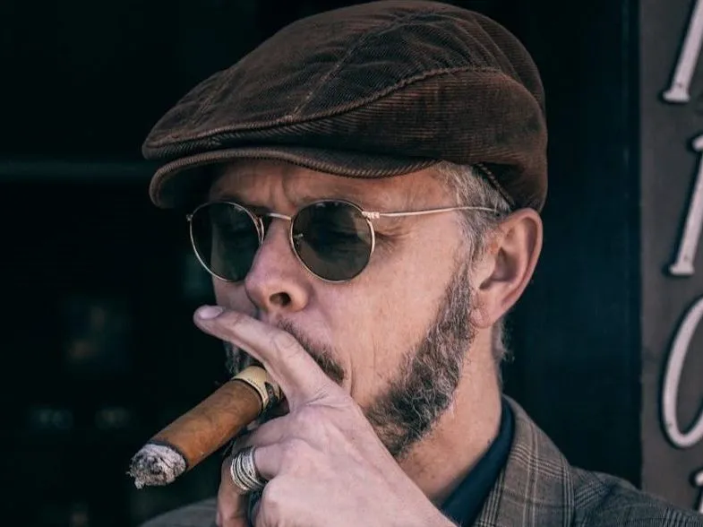 man-smoking-cigar-with-newsboy-cap-by-tim-mossholder-pexels-e1720488120184.webp.6ea67922fabab4acc3041df2dc0bbb13.webp